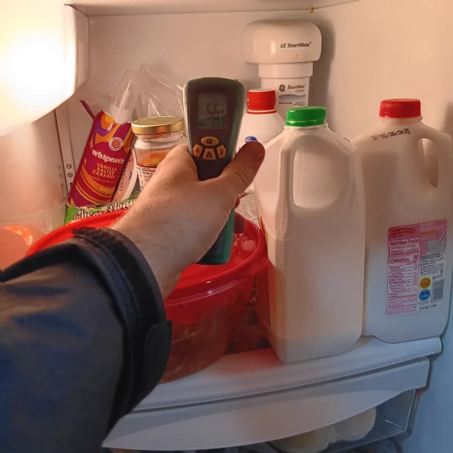 Infrared laser thermometer reading 56.5 degrees Fahrenheit warm refrigerator diagnostics in Alpharetta GA