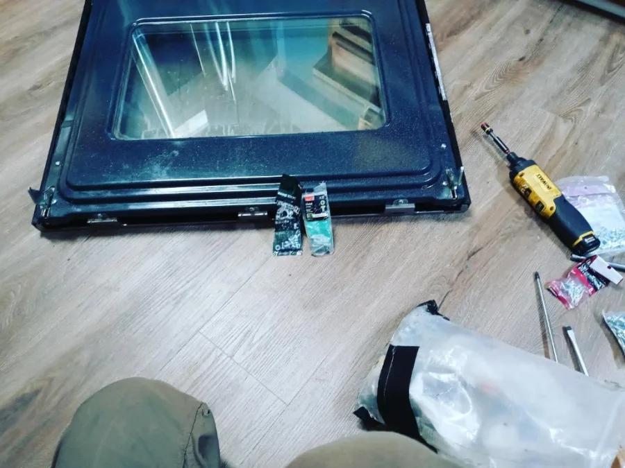 Oven door hinge rebuild with glass pane and DeWalt driver in Alpharetta GA